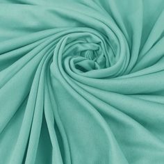 a close up shot of the fabric in aqua green color, with very soft folds