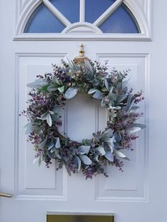 a white door with a wreath on it