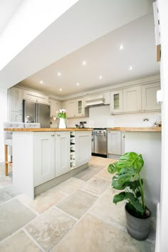 a large kitchen with white cabinets and an island