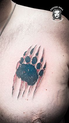 a man's chest with a bear paw tattoo on it