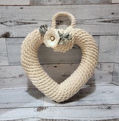 a heart shaped rope decoration with flowers on it