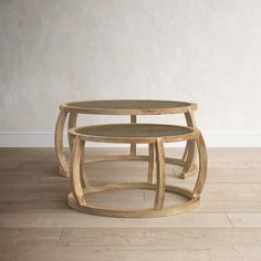 two wooden tables sitting side by side on top of a hard wood floor in front of a white wall