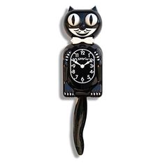 a black cat clock with white numbers on it's face and tail, sitting in front of a white background