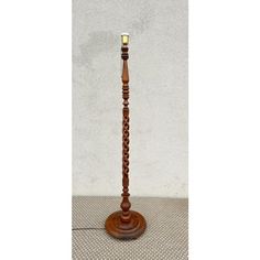 a tall wooden candle holder with two candles