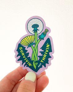 a person holding up a sticker with a flower on it's back and the words, happy earth day