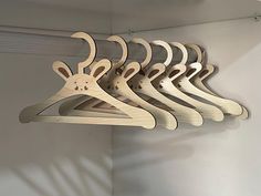 a bunch of wooden clothes hangers hanging on a wall