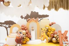 a birthday party with lion decorations and balloons