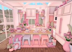 a pink kitchen with lots of furniture in it