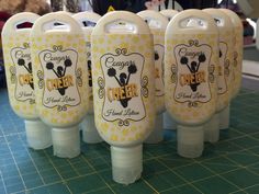 four plastic containers are lined up on a table with yellow and white designs in them