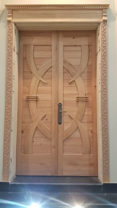 two wooden doors with intricate carvings on the front and side panels, in an ornate frame