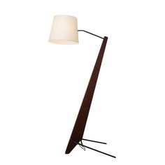 a floor lamp with a white shade on it