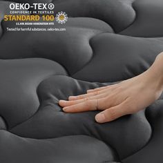 a person's hand resting on an overstuffed mattress