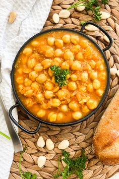 a bowl of chickpeas and bread on a table