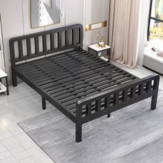 a black bed frame sitting on top of a white floor next to a large window