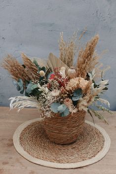 a basket filled with lots of flowers sitting on top of a table