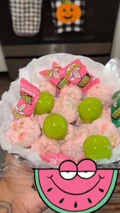 a hand holding a bag filled with candy