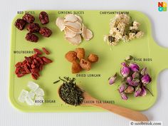 a green tray filled with different types of dried flowers and herbs on top of it