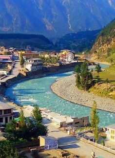 a river flowing through a lush green valley