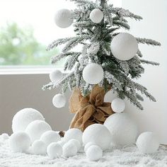 a small christmas tree with white balls on it