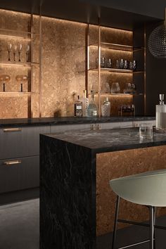 a modern kitchen with marble counter tops and wooden shelving behind the bar, along with wine glasses on shelves