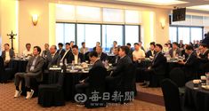 a large group of people sitting at tables