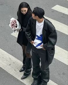 a man and woman are standing on the street