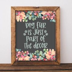 a dog is just part of the decor framed in a wooden frame on top of a shelf