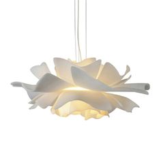 a white light hanging from a ceiling fixture with flowers on the bottom and one flower in the middle