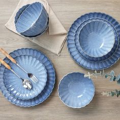 blue plates and utensils on a wooden table