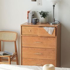 a bedroom scene with focus on the dresser and hat sitting on it's top