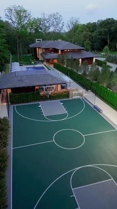 an aerial view of a basketball court and house