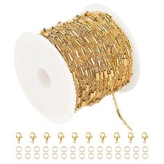 a spool of gold colored wire with lots of hooks and chains around the spool