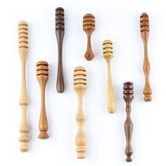 six wooden combs are lined up against a white background