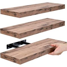 two wooden shelves are shown with one being held by a hand and the other is holding an object