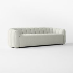 a white couch sitting on top of a white floor