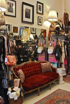 a red couch sitting in front of a mirror