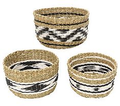 three woven baskets with black and white designs on the bottom, one has a small round basket