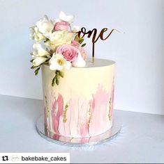 a cake decorated with pink and white flowers