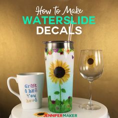 a white table topped with two cups and a sunflower painted on the side of it