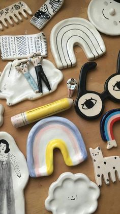 many different items are laid out on a wooden table with scissors, pens and magnets