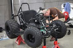 a man is working on an electric vehicle