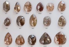 a group of different colored diamonds sitting on top of a white table next to each other