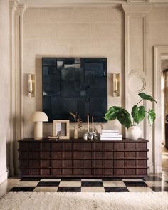 a living room with a black and white checkered floor, large painting on the wall