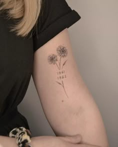 a woman with a tattoo on her arm that says, only love and two dandelions