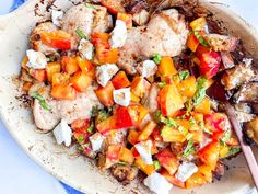 a white plate topped with meat and veggies on top of a blue table