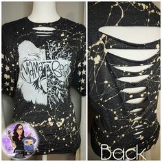 a black shirt with gold splattered paint on it