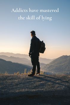 a man standing on top of a hill with a backpack in his hand and the words, adicts have mastered the skill of flying