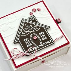 a close up of a card with a house and candy canes on the front