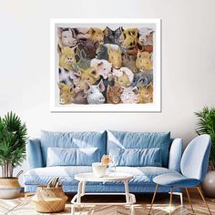 a living room with a blue couch and several cats on it's wall in front of a coffee table