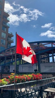 a canadian flag flying in front of a building